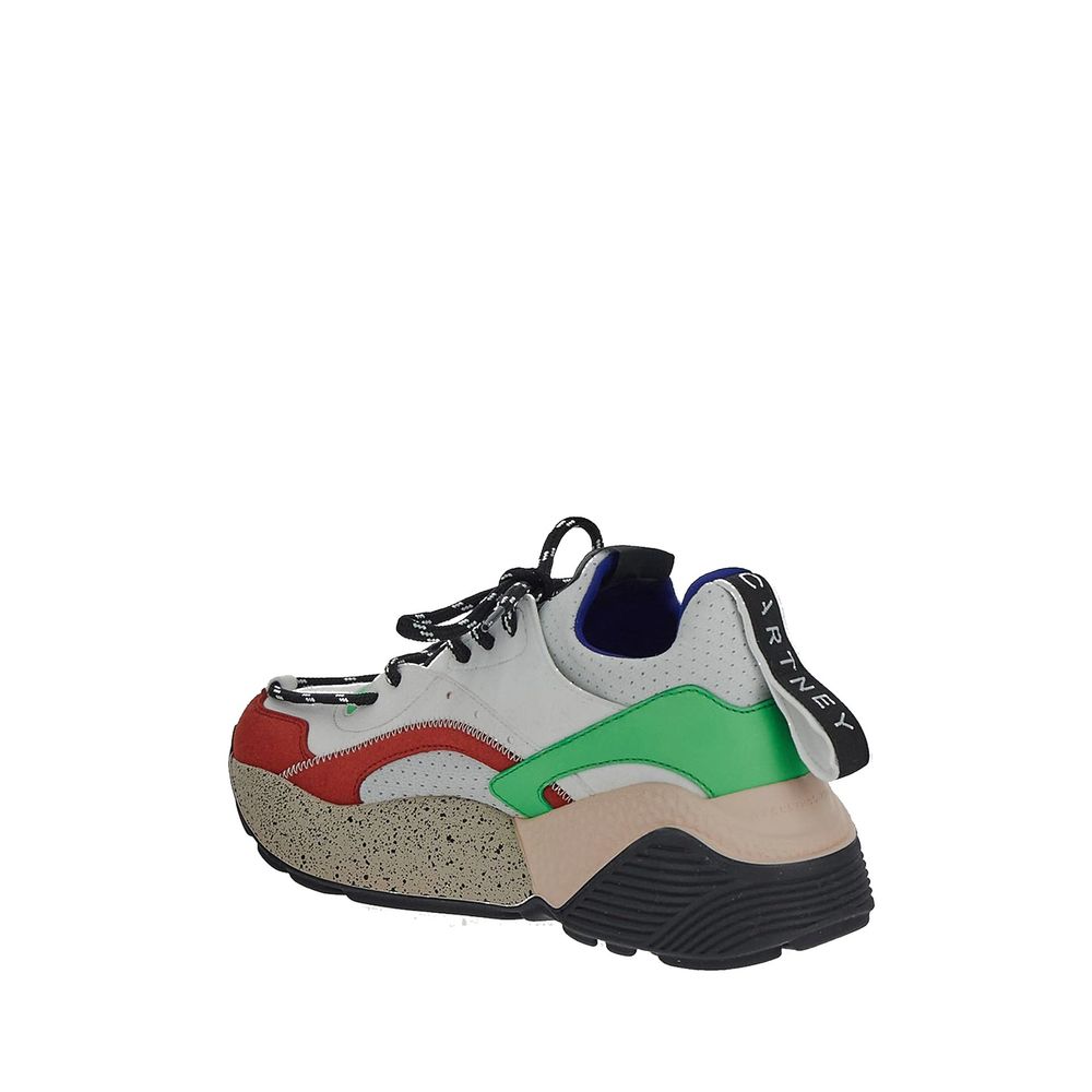 White sneaker with red, green, and black accents