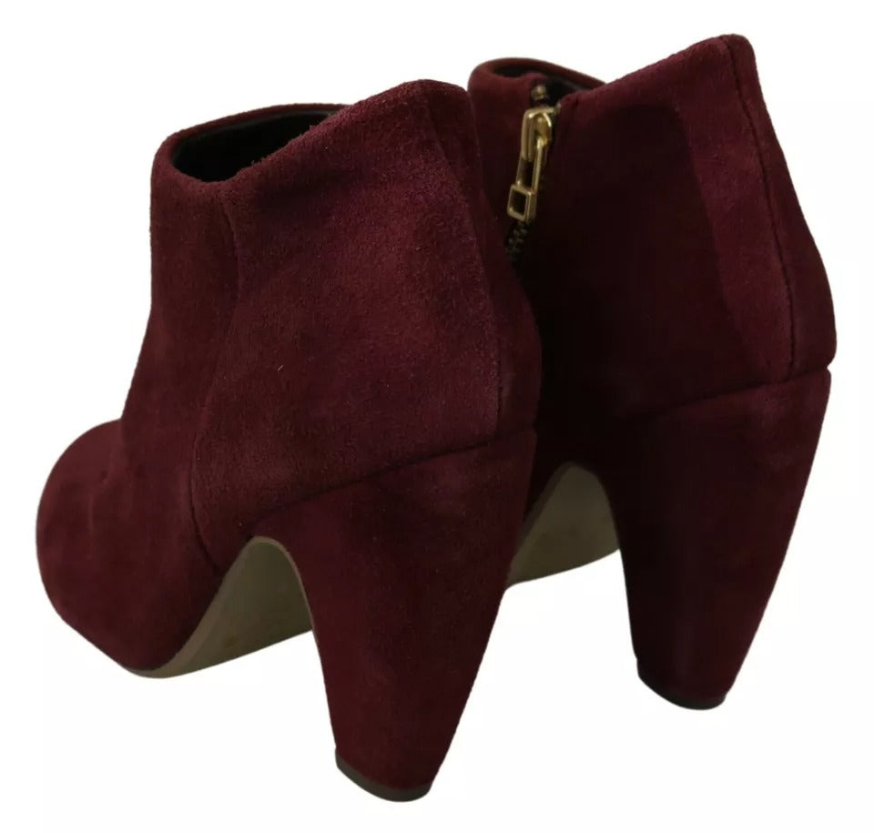Pair of burgundy suede boots with heels