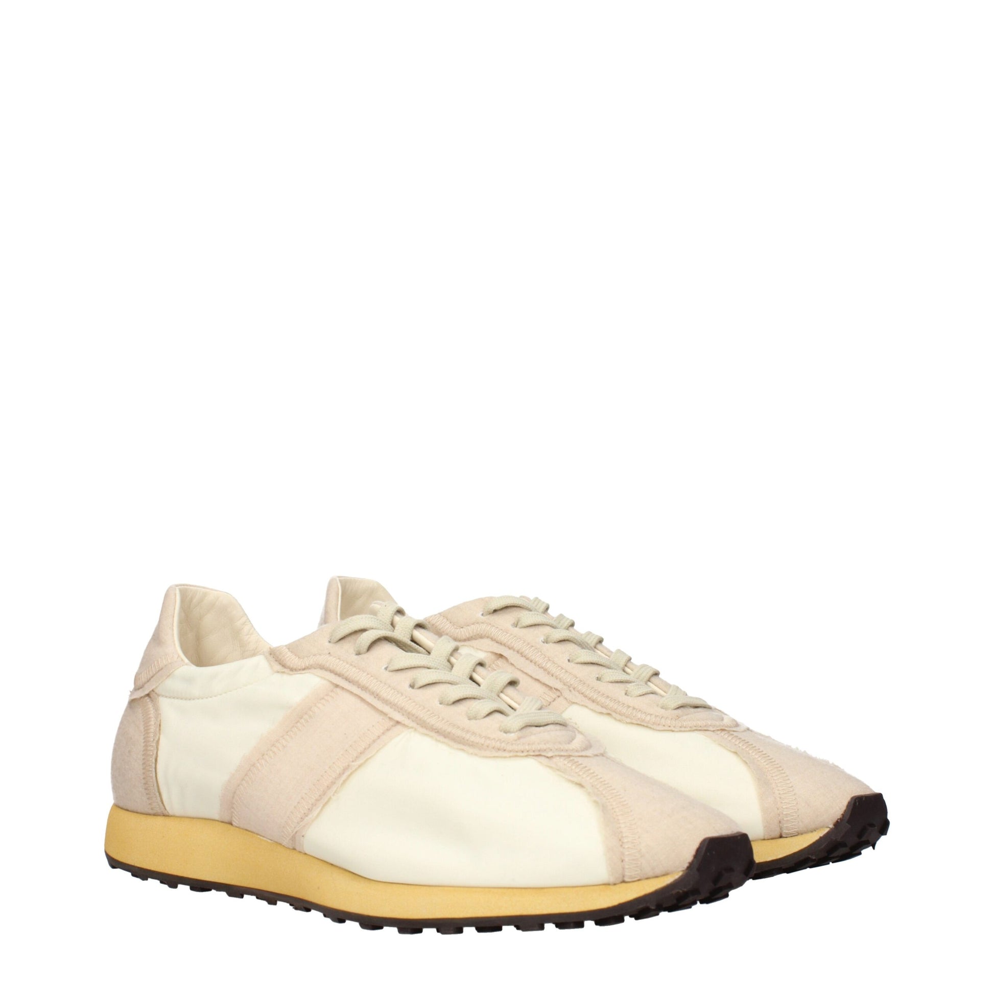 Tan canvas sneakers with white laces and yellow soles