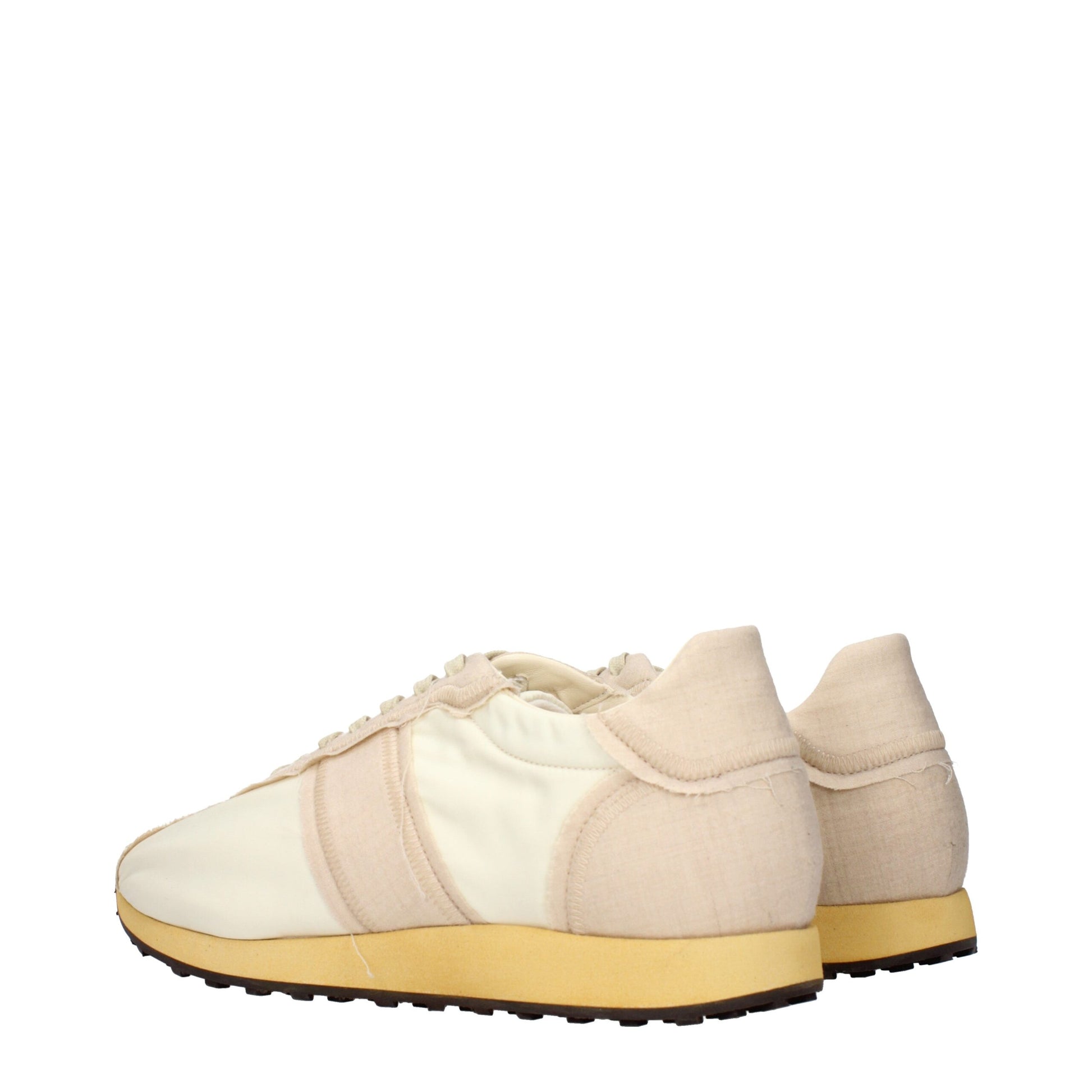 Tan canvas sneakers with white laces and yellow soles