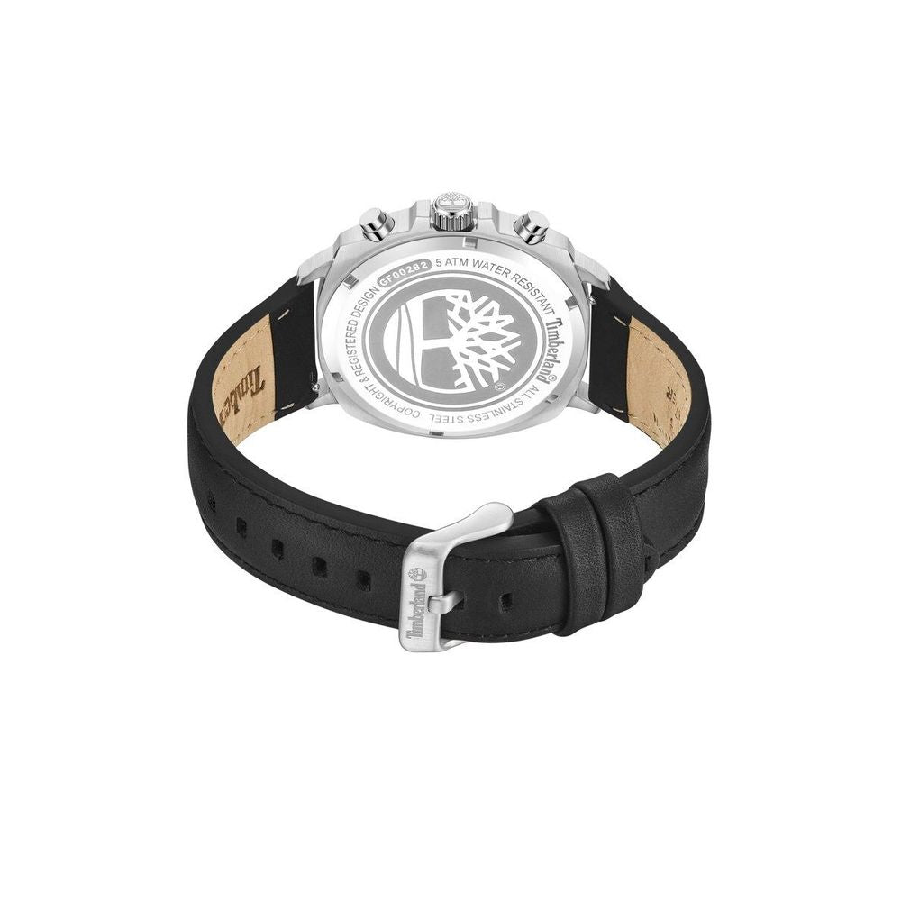 A black leather watch with a silver buckle and an orange logo on the face