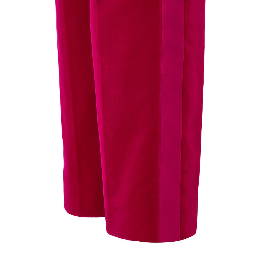 A pair of pink velvet dress pants with a satin stripe down the side