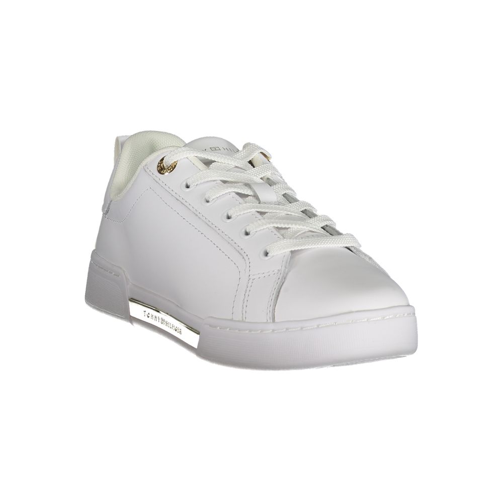 White sneaker with gold accents and a white sole