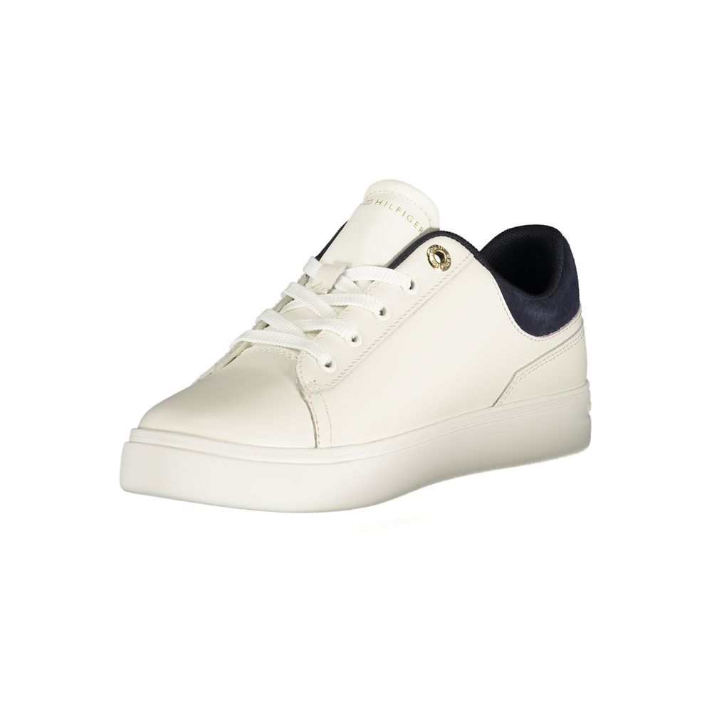 White sneaker with blue laces, featuring a gold buckle and logo on the side
