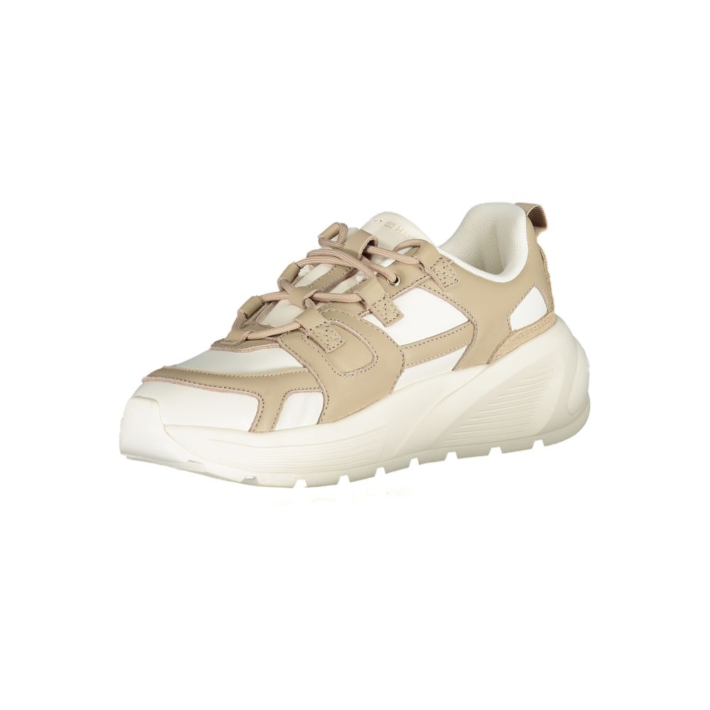 Tan shoe with laces and a strap across the foot