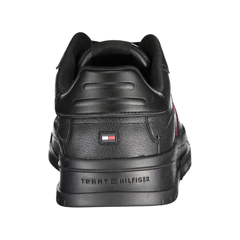 Black sneaker with red logo on side and black laces