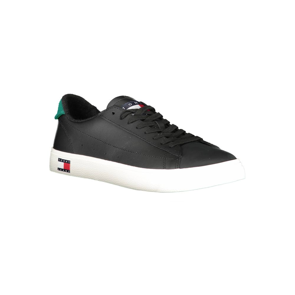 Black sneaker with white sole and green stripe on side