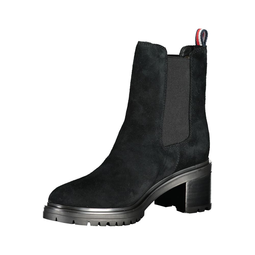 Black suede boot with a thick heel and a small zippered pocket on the side