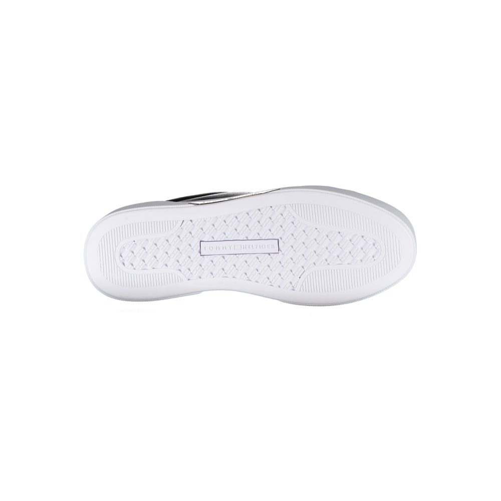 White sneaker with black logo on side