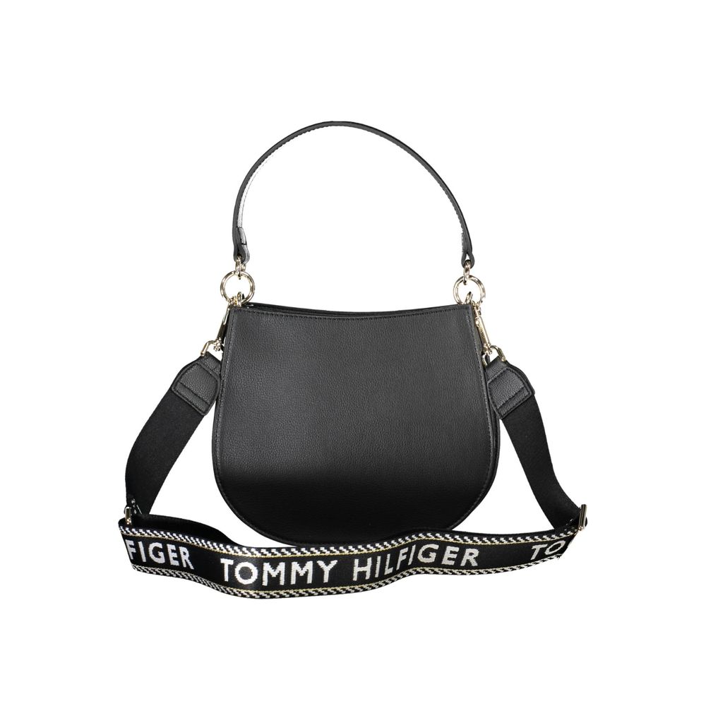 Black leather handbag with gold hardware and a strap featuring the brand name Tommy Hilfiger in white letters