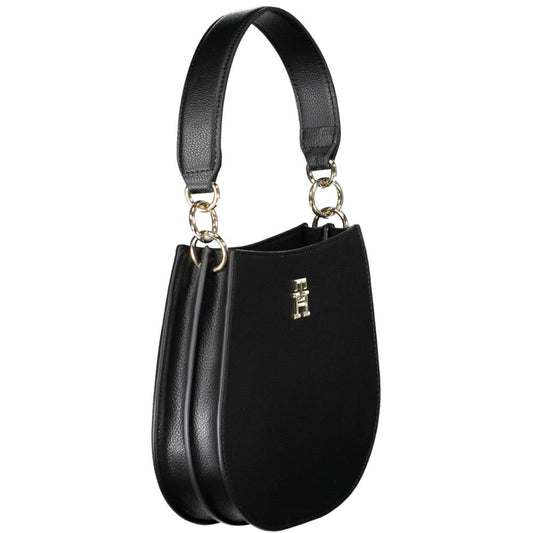 Black leather handbag with gold hardware and a logo on the front