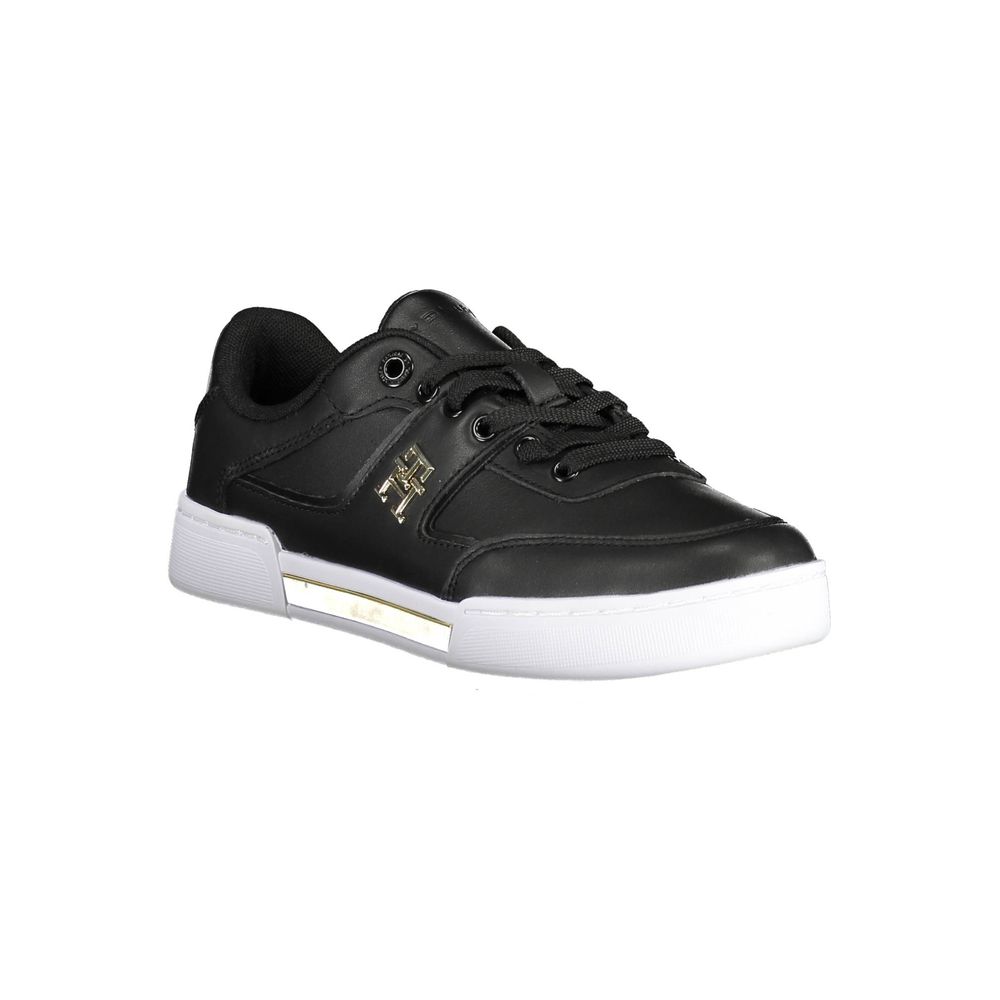A black women's sneaker with white sole, featuring a gold logo on side and laces