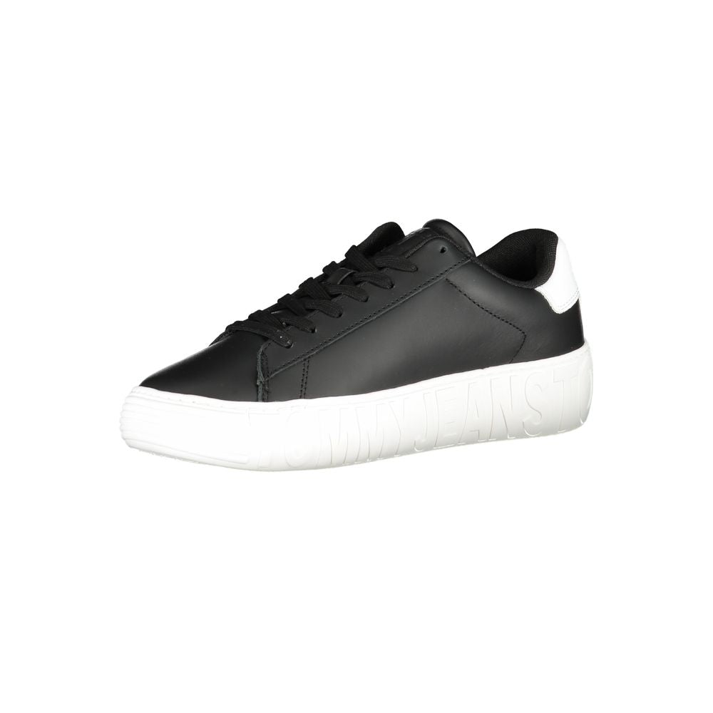 A black polyurethane men's sneaker with white laces and a low top