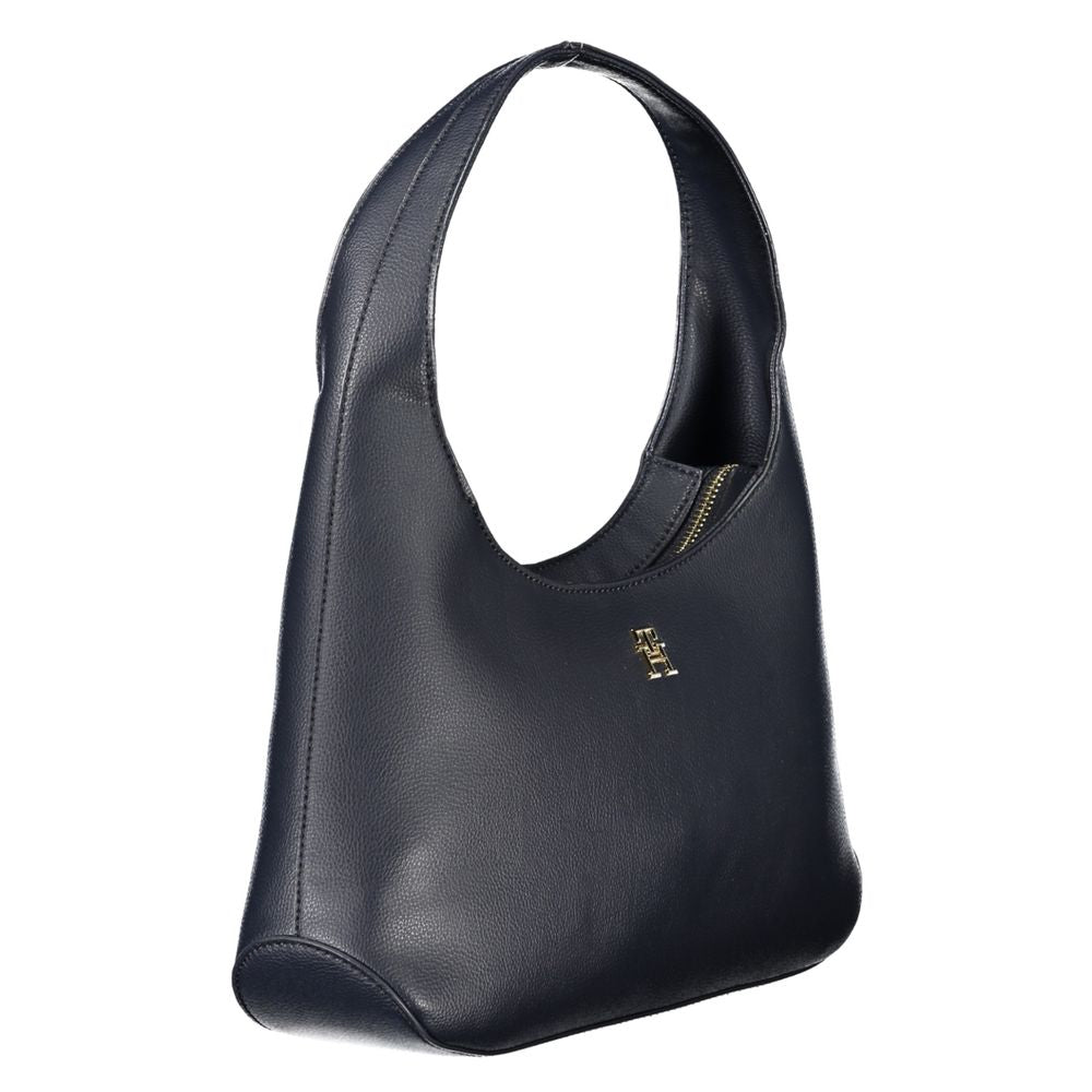 A dark blue handbag with a visible logo on the front. It appears to be made of leather or a leather-like material and has