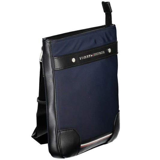 Blue and black bag with leather straps and a zippered pocket on front