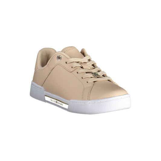 A women's pink leather sneaker with white sole, featuring a gold buckle and logo on the side