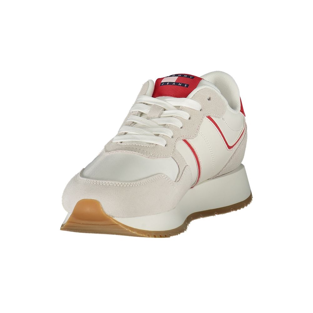 A woman's tennis shoe with a white upper, red accents, and a tan sole