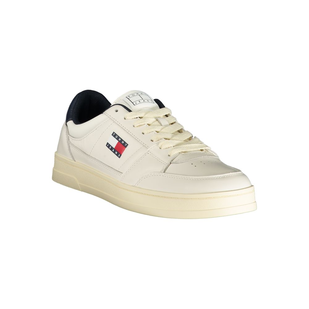 A white leather men's sneaker with a gold sole, featuring a red logo on the side and a black lace