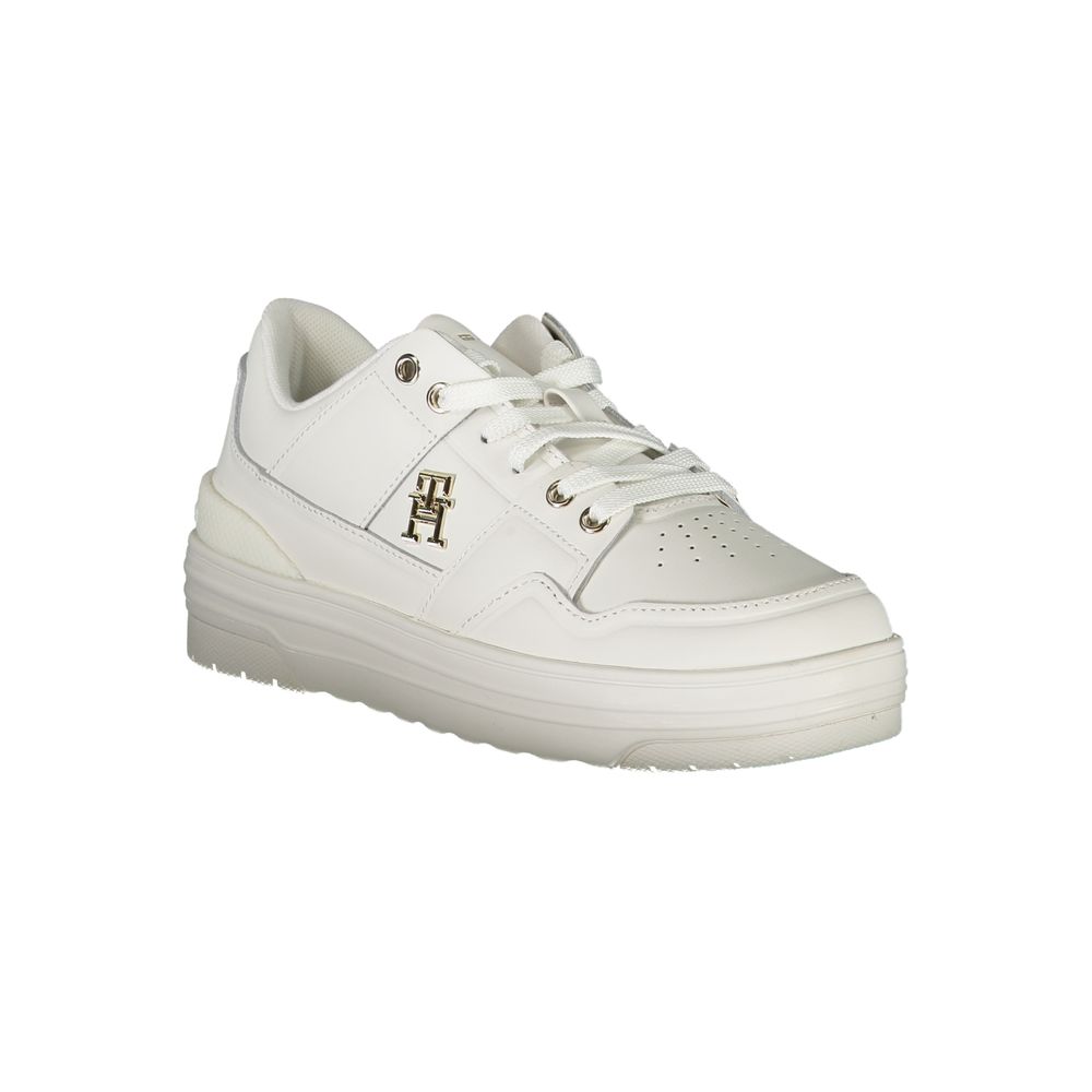 White sneaker with gold accents and laces
