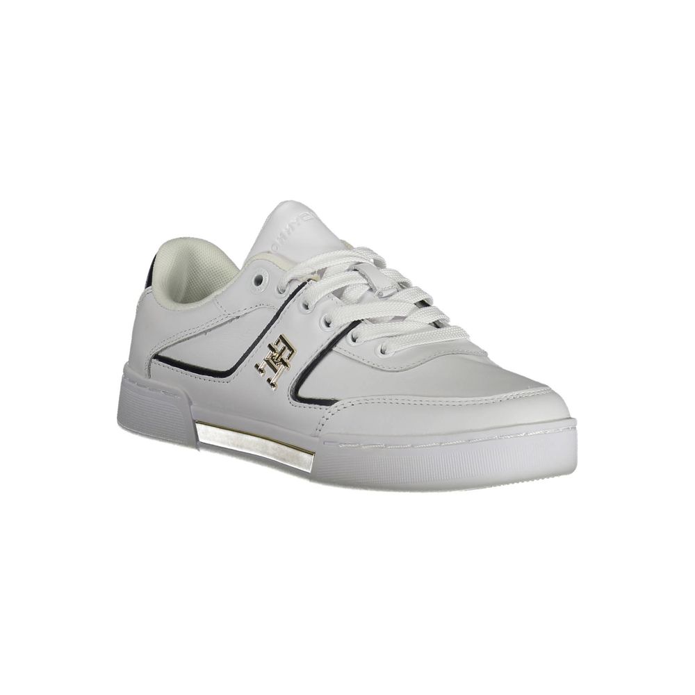White sneaker with gold accents and a logo on the side