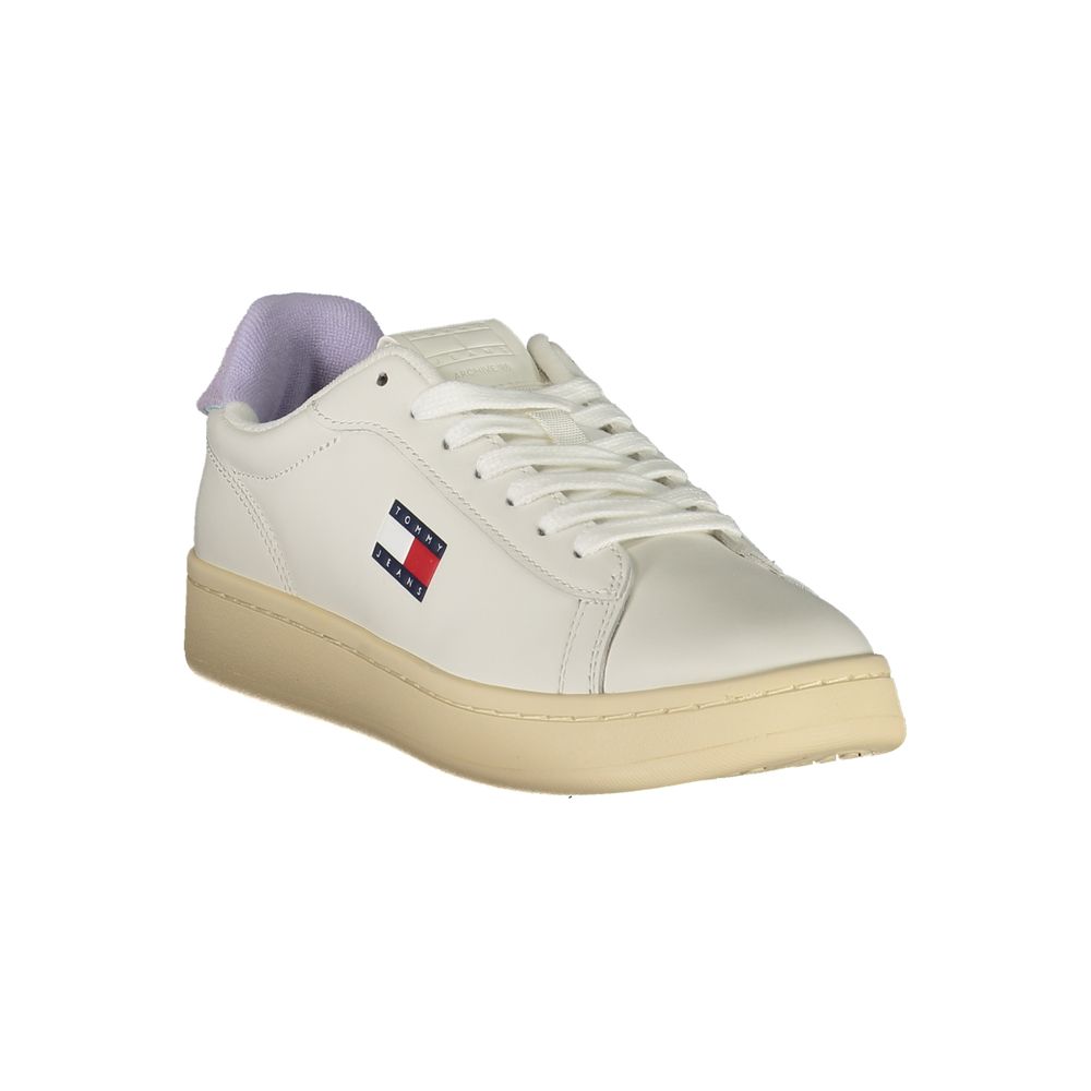 A white women's sneaker with a purple logo on the side and tan soles