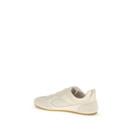 A pair of beige sneakers with a logo on the side, made of polyester material
