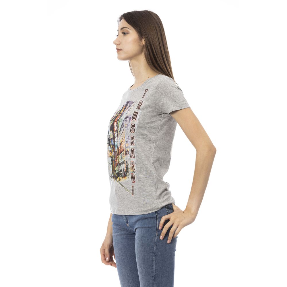 Woman wearing gray t-shirt with graphic design on front