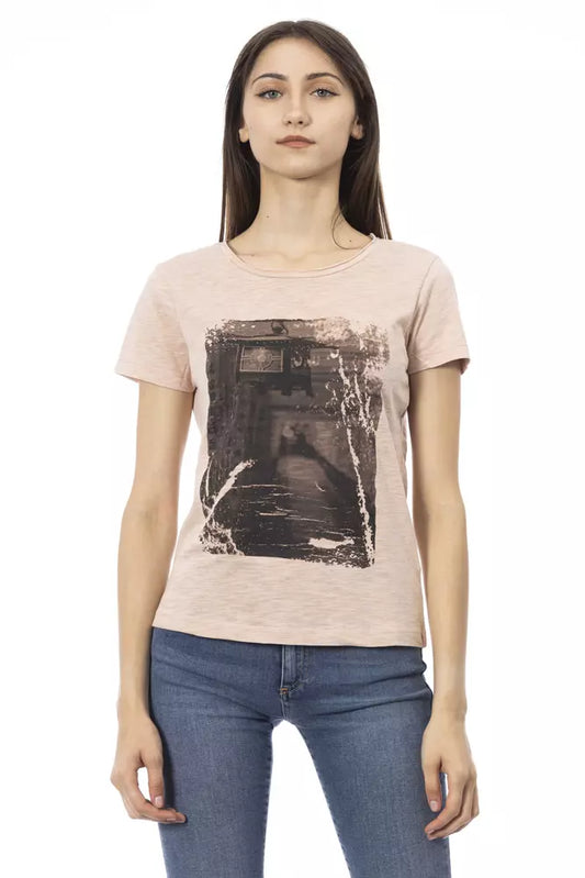 Woman wearing a pink t-shirt with a black and white graphic print on it