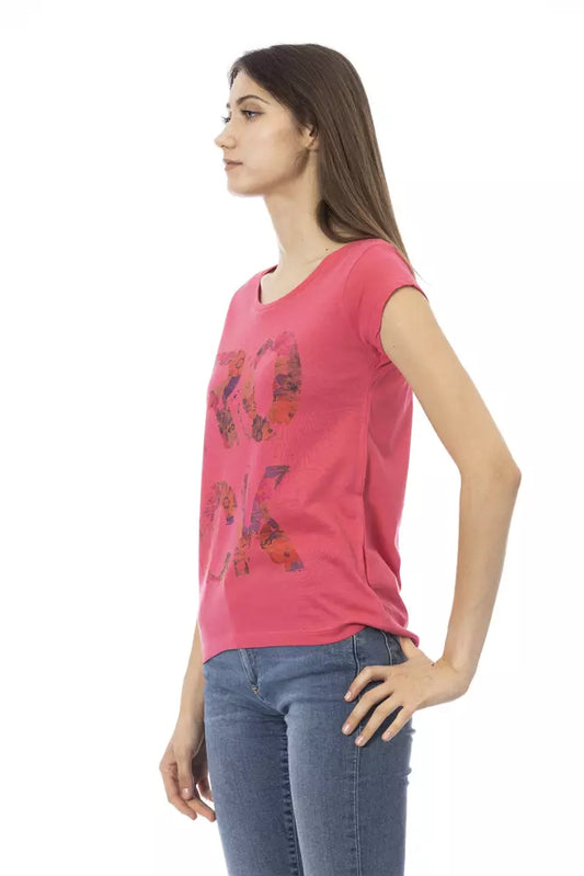 Woman wearing pink shirt with graphic design on front