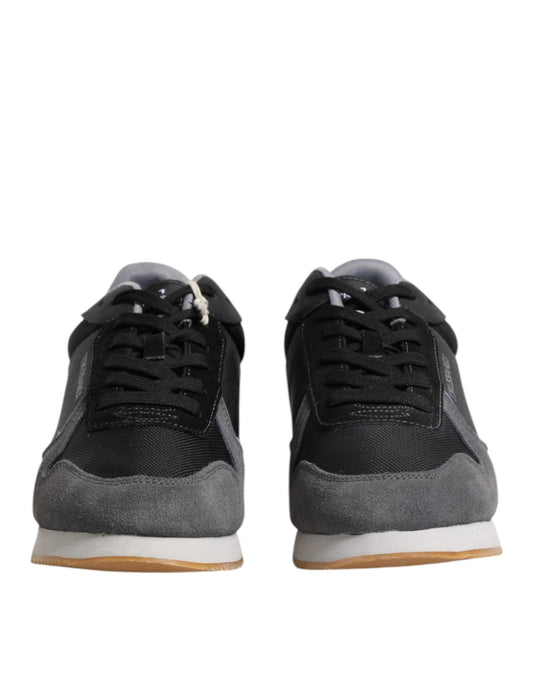 Pair of black sneakers with white laces