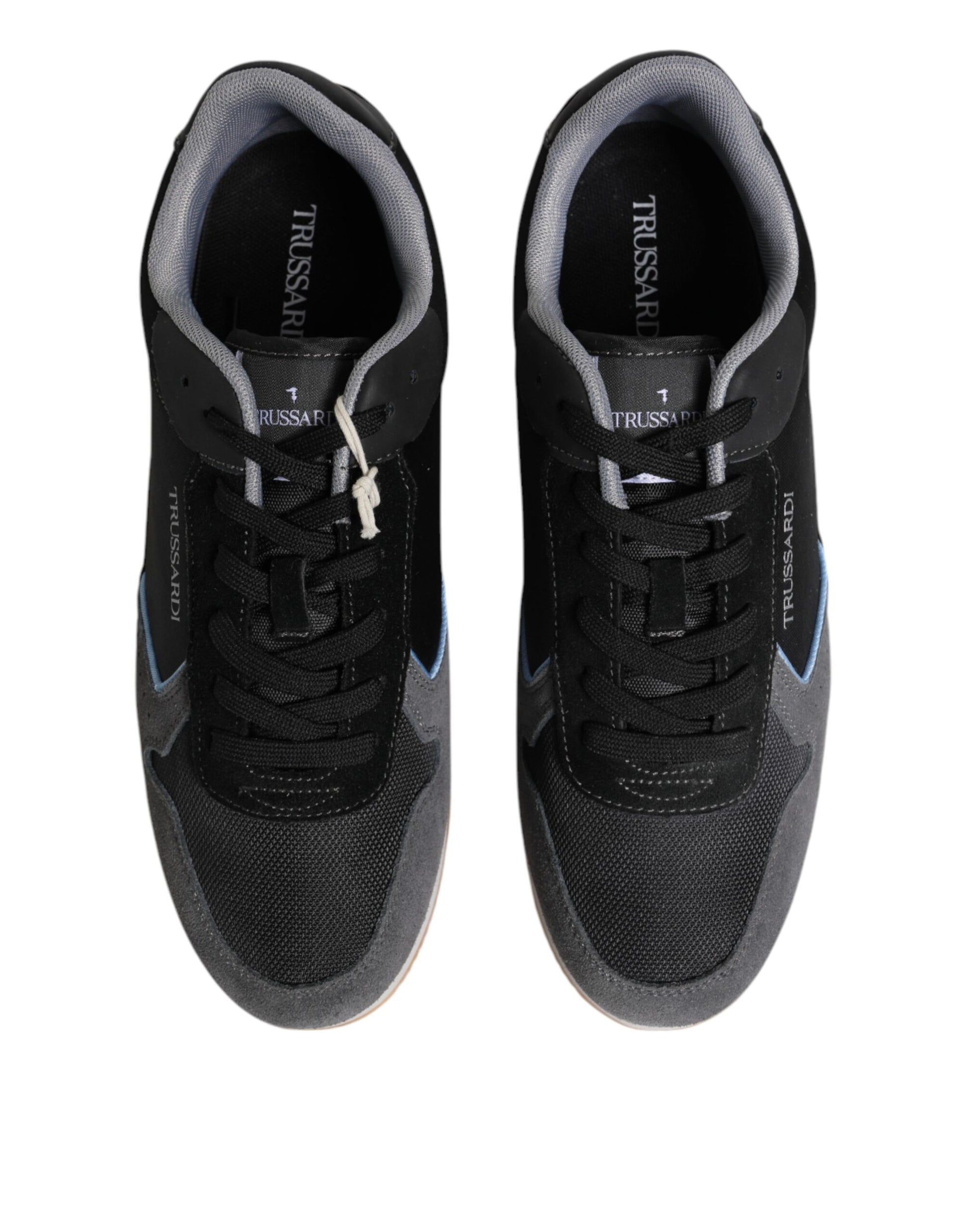 Pair of black sneakers with white laces