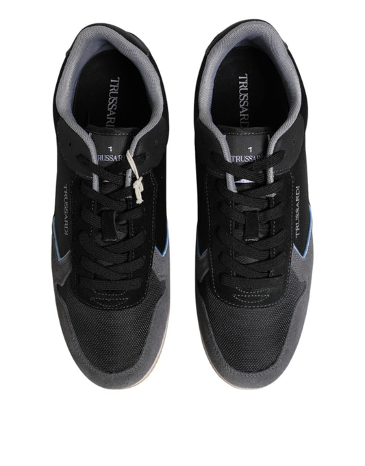 Pair of black sneakers with white laces