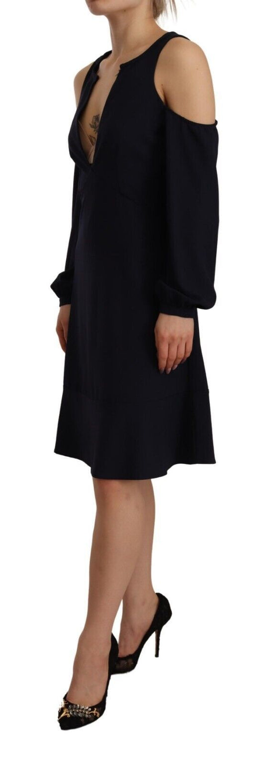 Woman wearing a black dress with long sleeves and off-the-shoulder design