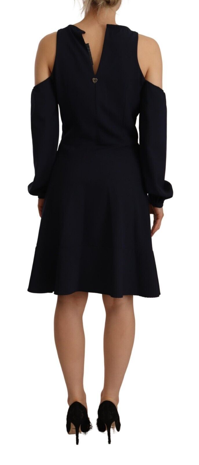 Woman wearing a black dress with long sleeves and a high neckline