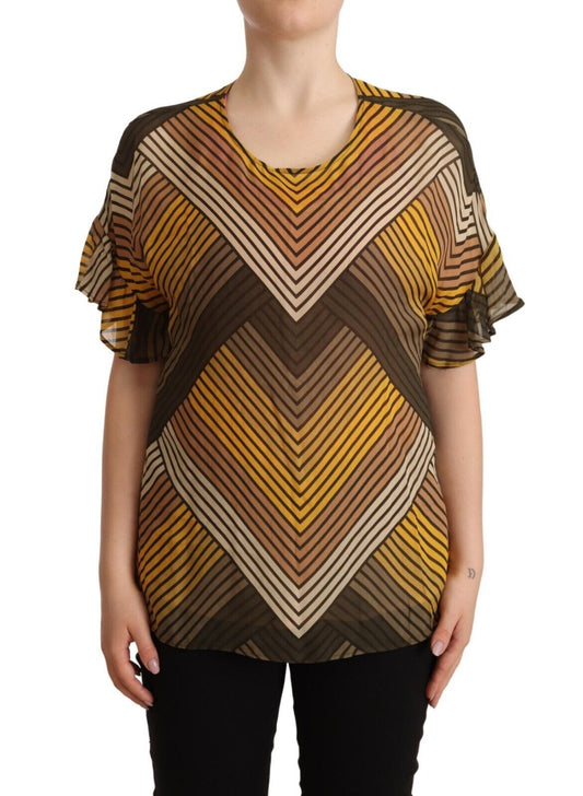 The woman is wearing a long sleeve top with a geometric pattern