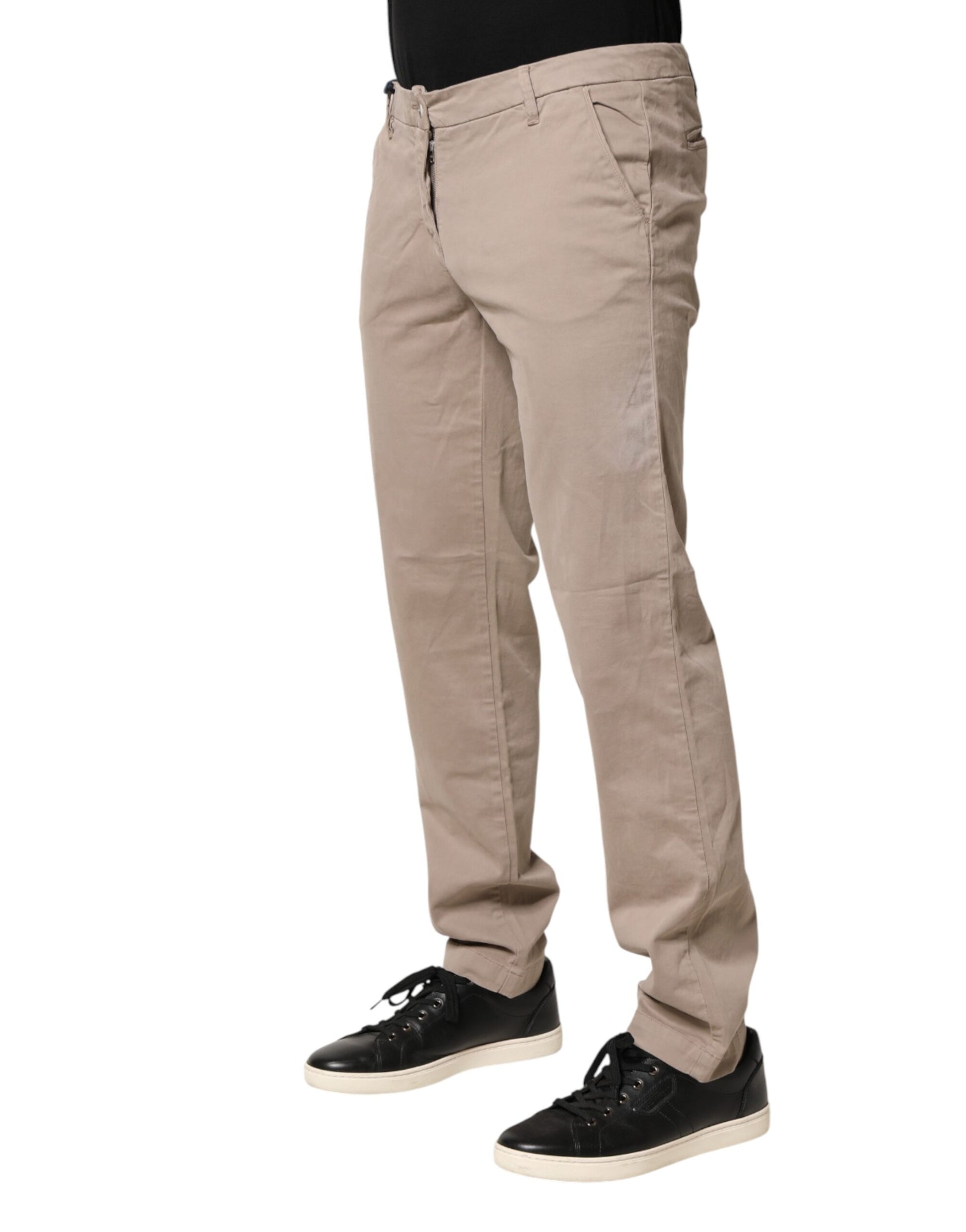 Khaki pants worn by a person standing against a white background