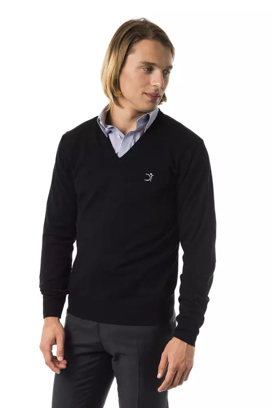 Man wearing black sweater and gray pants