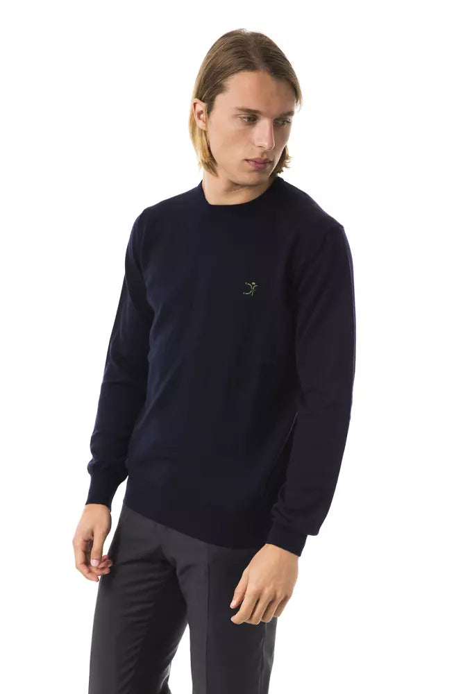 Man wearing dark blue sweatshirt with emblem on left chest
