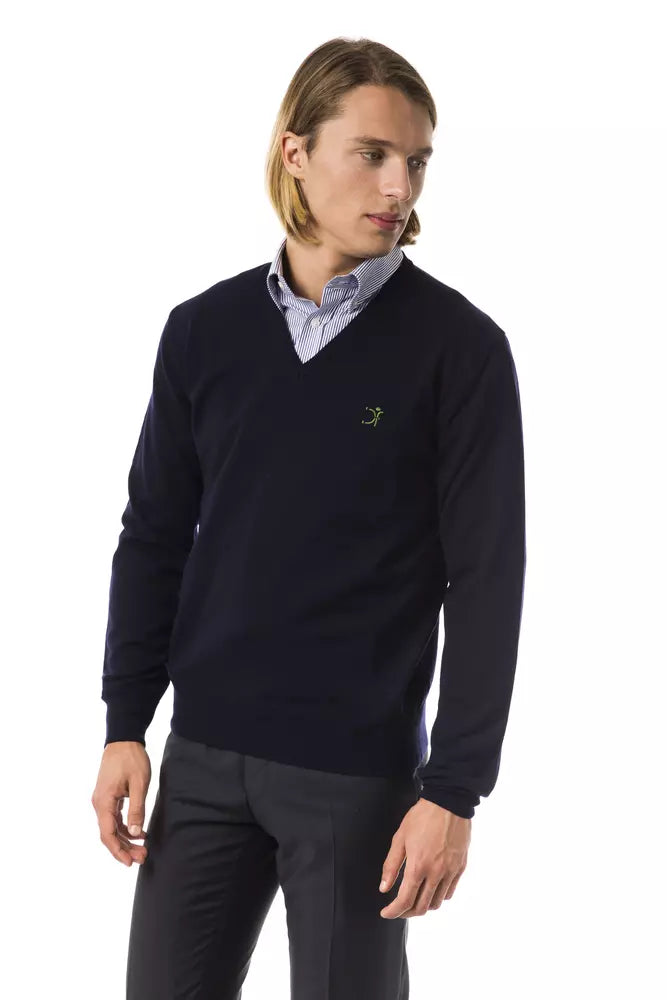 Man wearing dark blue sweater with logo on left chest
