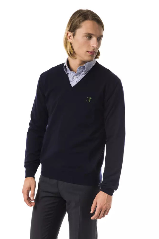 Man wearing dark blue sweater with logo on left chest