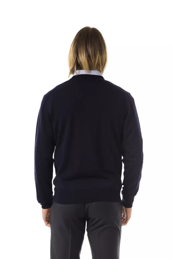 Dark blue sweater worn by a person standing against white background