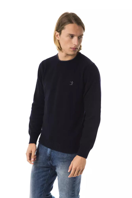 Man wearing black sweater with white logo
