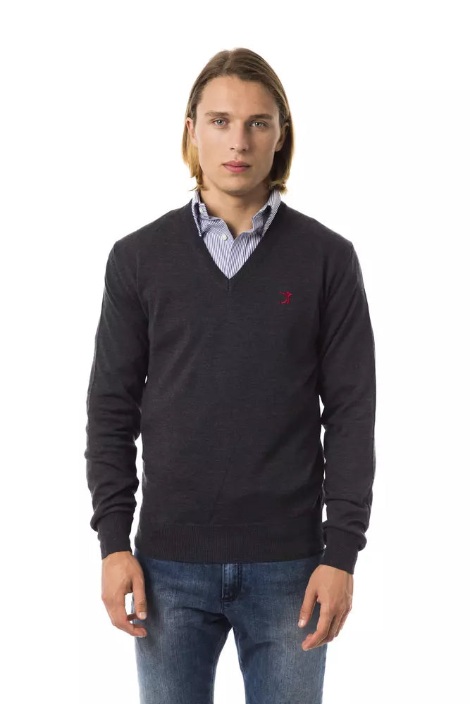Man wearing dark sweater and light blue jeans