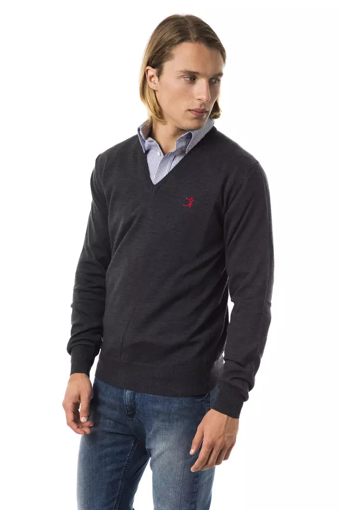Man wearing dark sweater and blue jeans