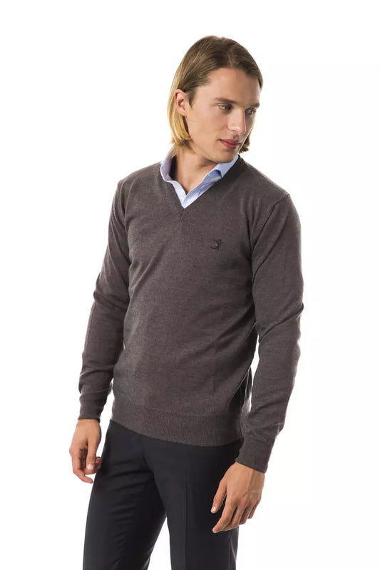 Man wearing dark sweater and light pants