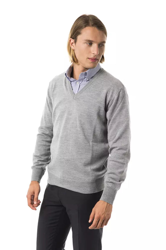 Man wearing gray sweater and black pants