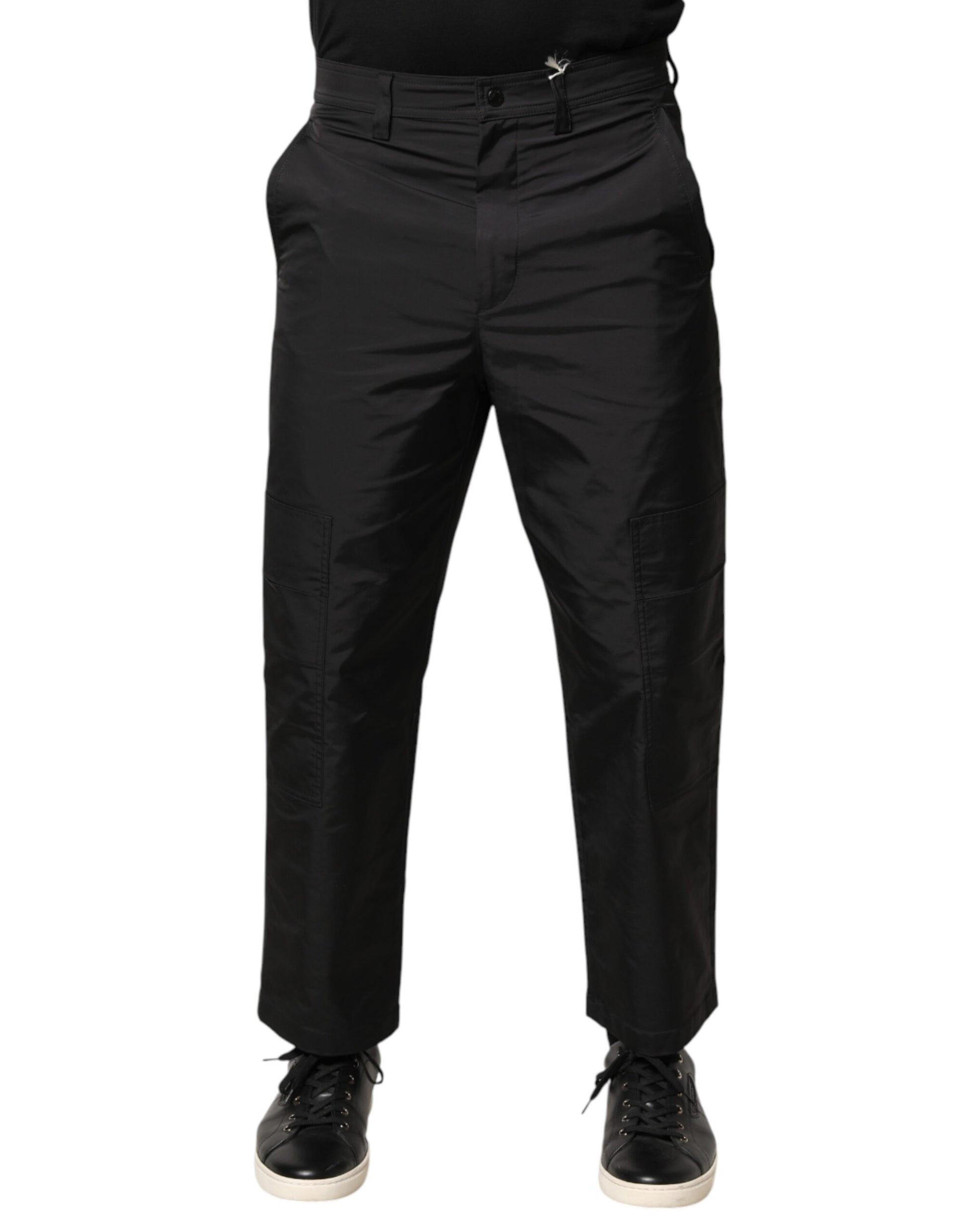 A pair of black men's trousers with a mid-waist design and tapered legs
