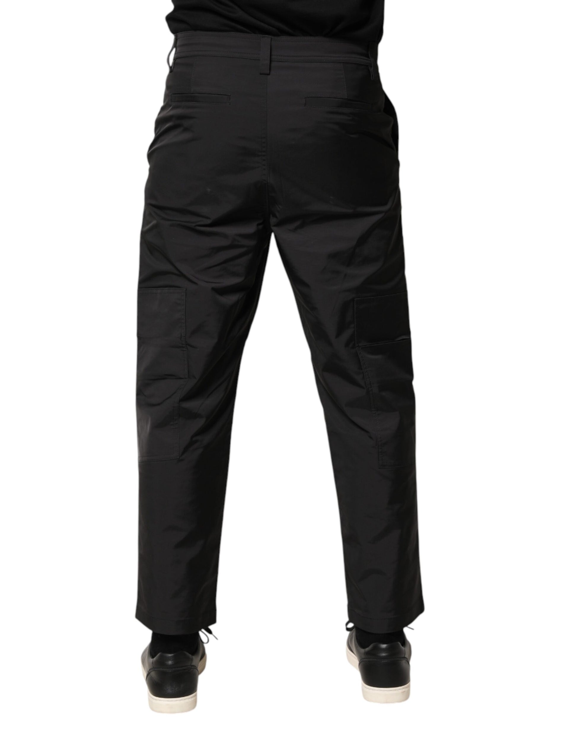 A pair of black men's trousers with a tapered design, mid-waist, and visible pockets