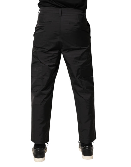 A pair of black men's trousers with a tapered design, mid-waist, and visible pockets