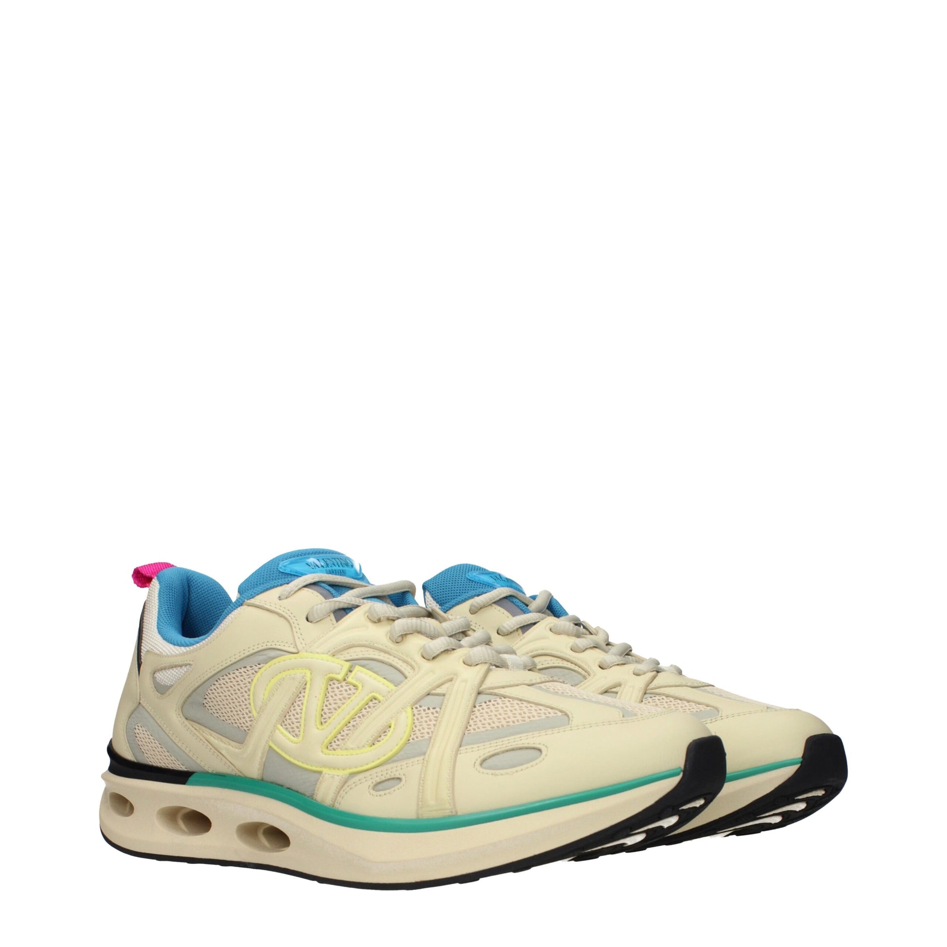 A pair of beige athletic sneakers with a logo on the side, featuring laces and a cushioned sole